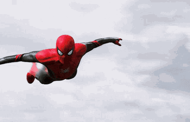 a spider-man is flying through the air with his arms outstretched