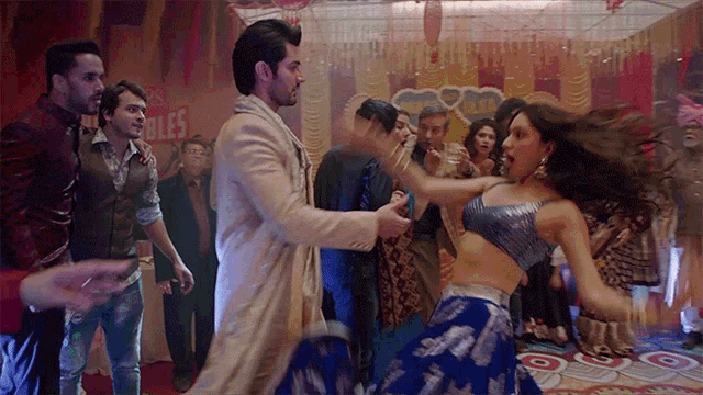 a man and a woman are dancing in front of a sign that says ' bubbles '