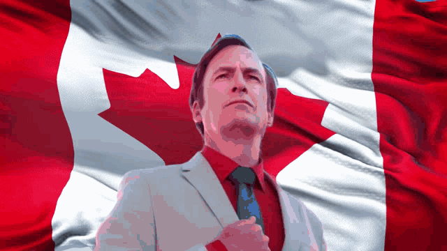 a man in front of a canadian flag with his hand on his chest