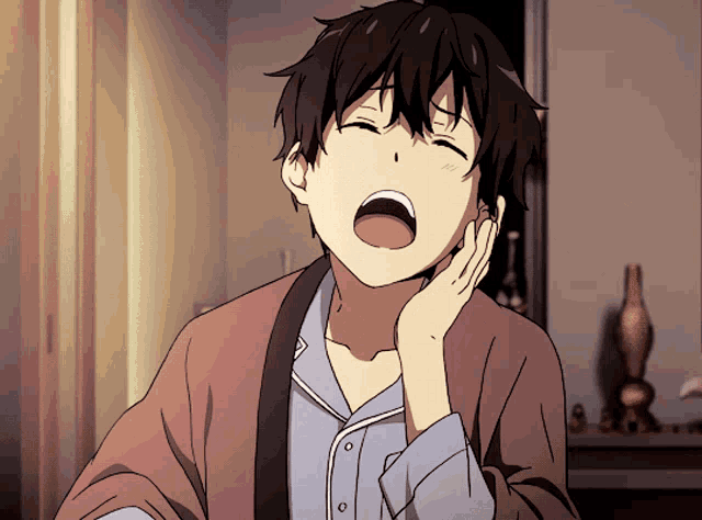 a boy yawning with his mouth open and his hand on his chin