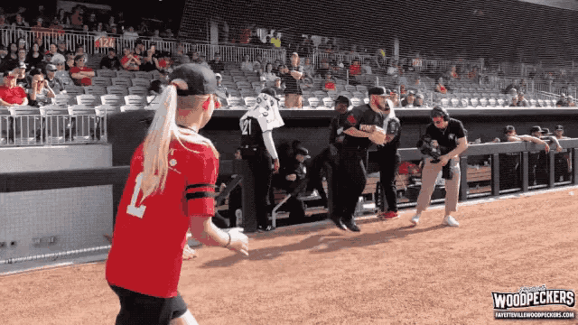 a girl in a red jersey with the number 12 on it