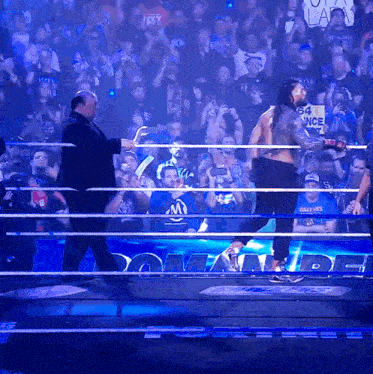 a man in a wrestling ring with a sign that says silence