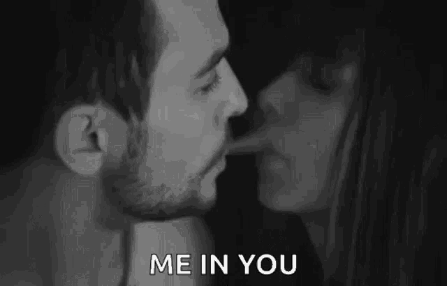 a man and a woman are kissing in a black and white photo with the words `` me in you '' .