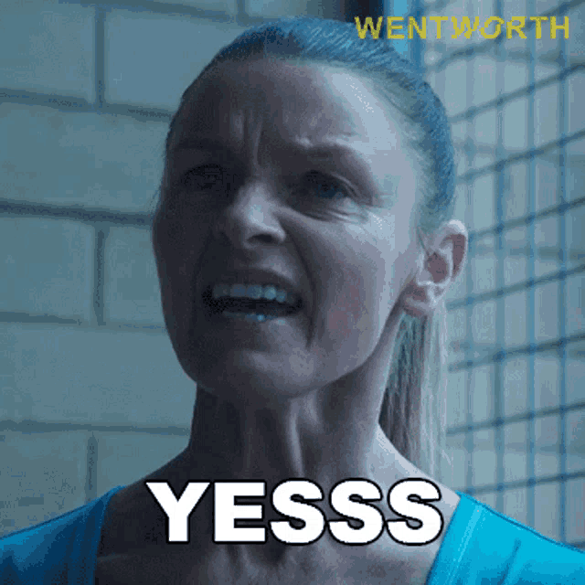 a woman in a blue shirt says yesss