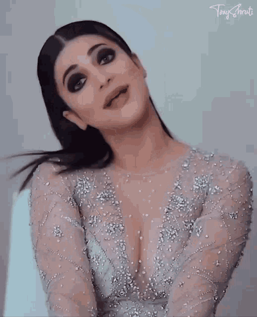 a woman wearing a very plunging neckline dress with the name tony written on the bottom