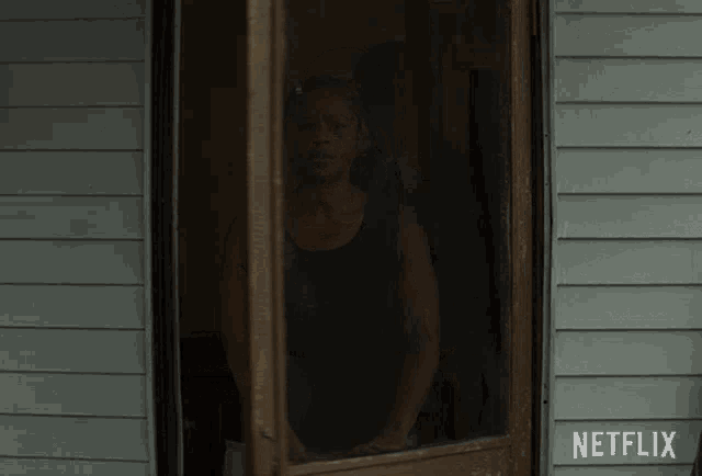 a netflix ad shows a woman standing in a doorway with the words right over there below her