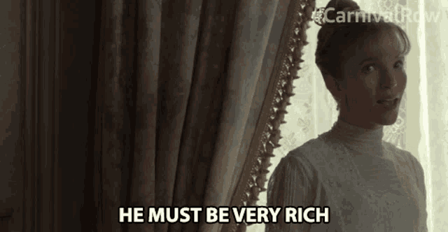 a woman says he must be very rich while standing next to a window