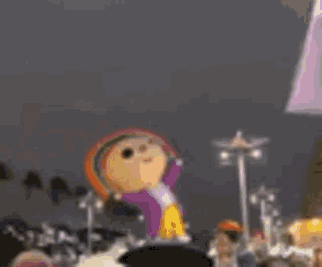 a cartoon character is standing on a stage in front of a crowd of people at night .