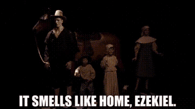 a group of people are standing in a dark room with the words it smells like home ezekiel