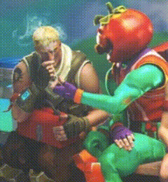 a man in a tomato costume is talking to another man in a green costume .