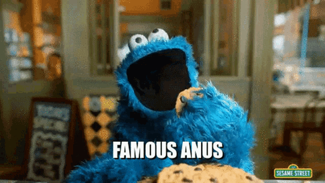 cookie monster from sesame street eating a cookie with the caption famous anus