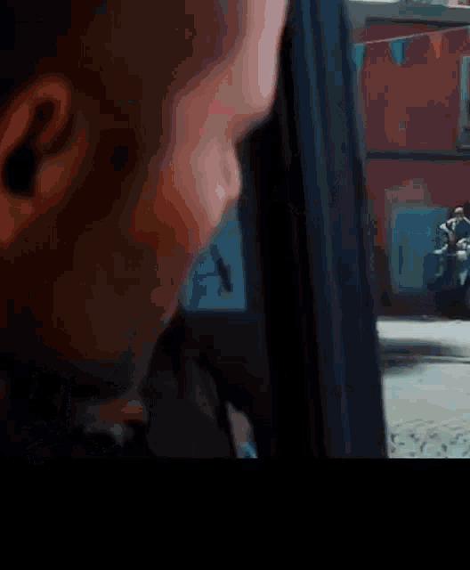 a man is looking out of a car window at a group of people riding scooters .