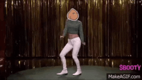 a woman is dancing on a stage wearing white pants and a green striped shirt .