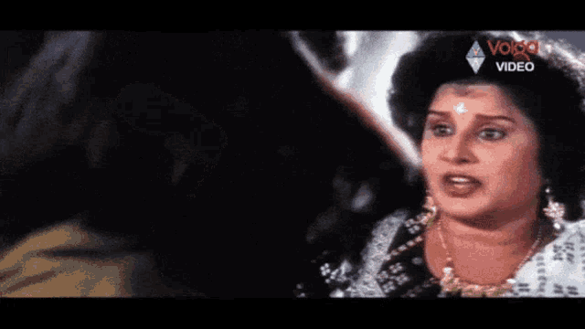 a woman is talking to another woman in a video that says ' video ' on it