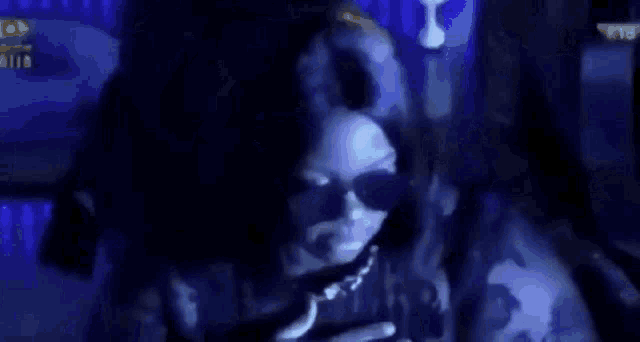 a group of people are standing next to each other in a dark room holding guns .
