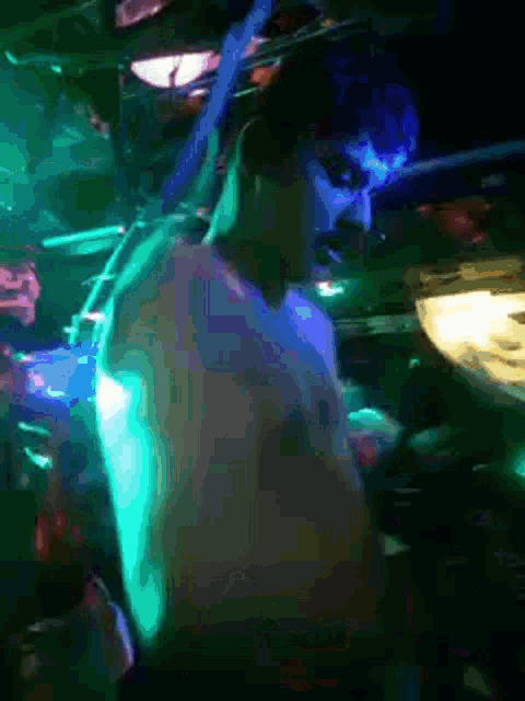 a shirtless man is dancing in a dark room