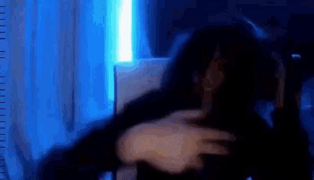 a blurry picture of a person in a dark room with a ruler in the background .