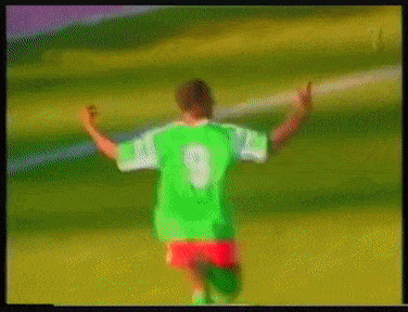 a blurry picture of a soccer player wearing a green jersey with the number 9 on it