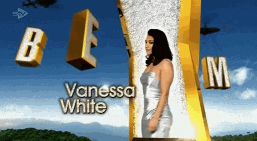 a woman in a white dress is standing in front of a sign that says ' vanessa white '