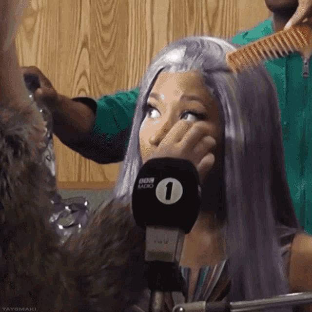 a woman wearing a wig and a microphone that says bbc radio 1