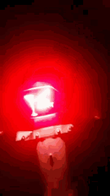 a red light is shining on a dark surface .