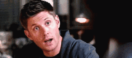 a close up of a man making a funny face while looking at the camera .