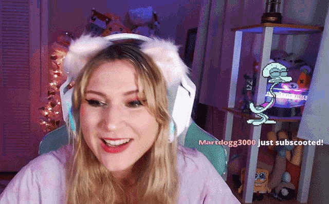 a woman wearing headphones and a cat ear headband says martdogg3000 just subscoated