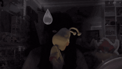 a person holding a cup with a drop of water on their head