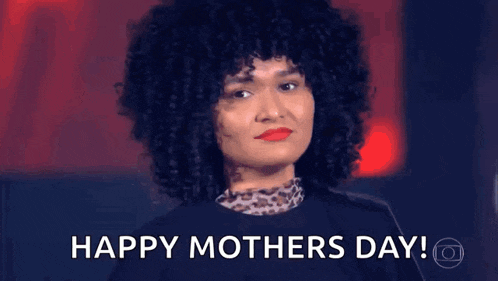 a woman with curly hair is hugging another woman and says `` happy mothers day '' .