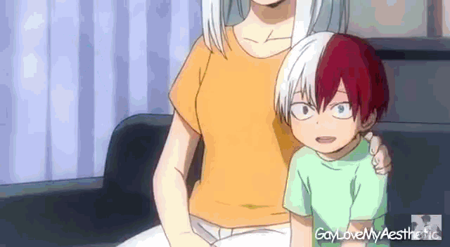 a woman is sitting on a couch next to a little boy .