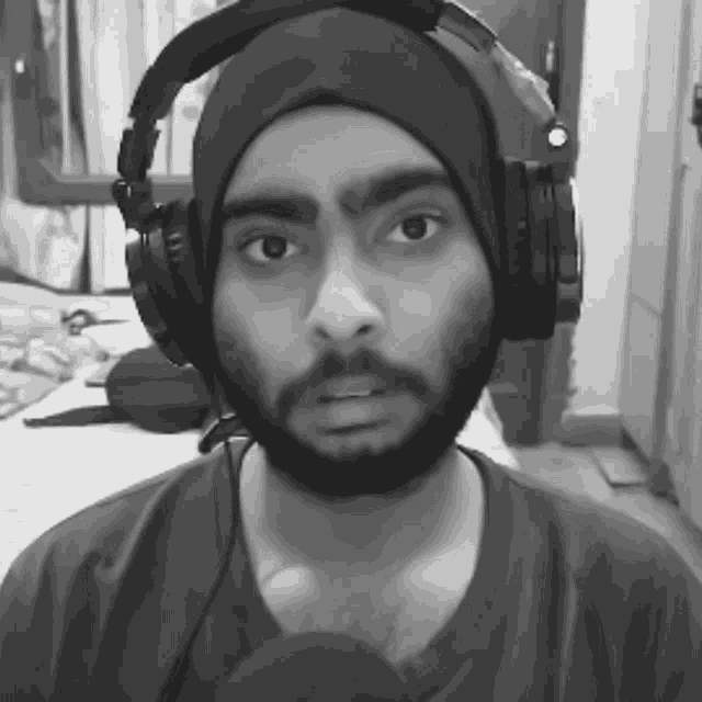 a black and white photo of a man wearing headphones