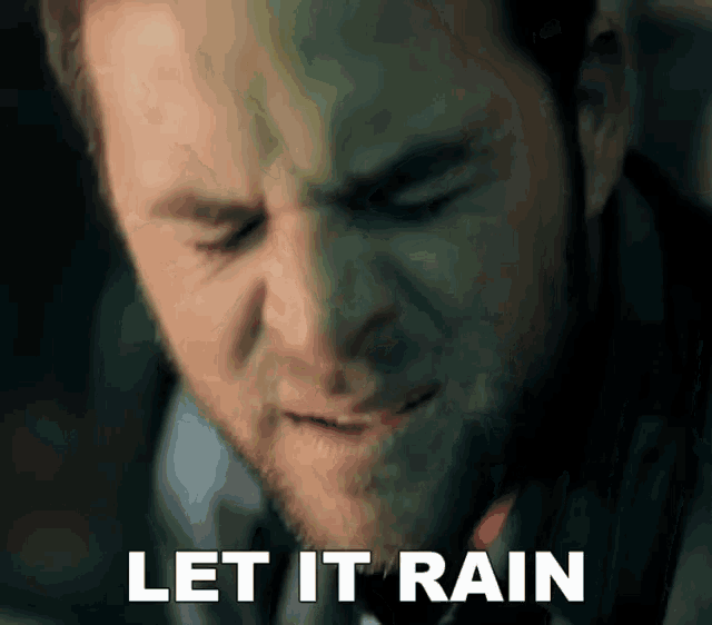 a close up of a man 's face with the words let it rain written below him