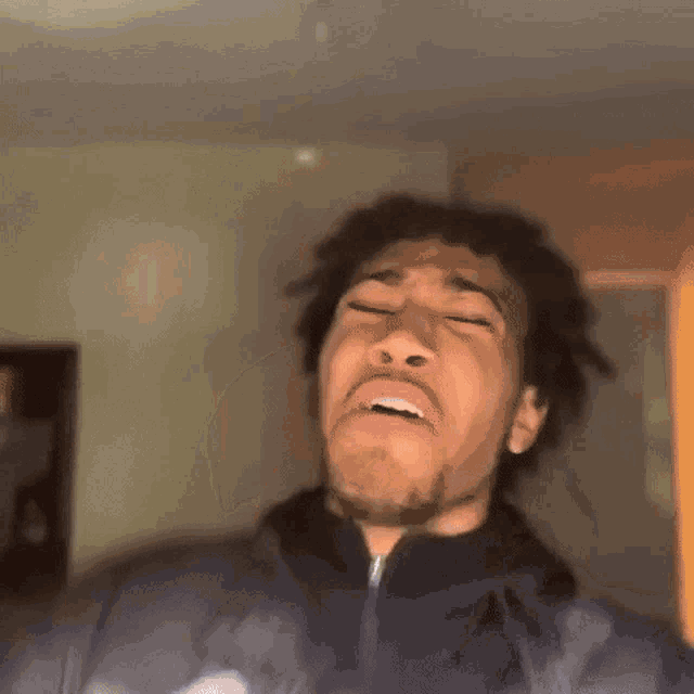 a blurry picture of a person 's face with a light shining on it .