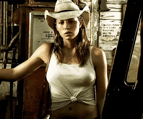 a woman in a cowboy hat is standing in front of a sign that says amount of $ 100
