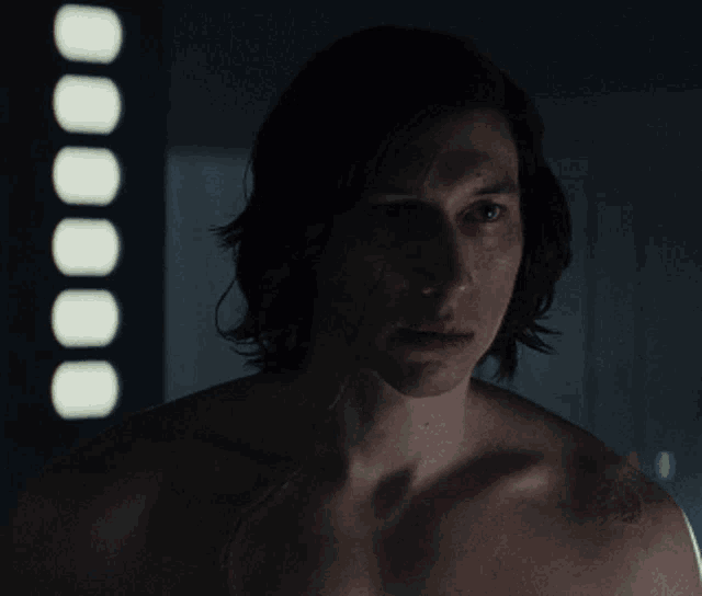 a man without a shirt is looking at the camera with circles in the background