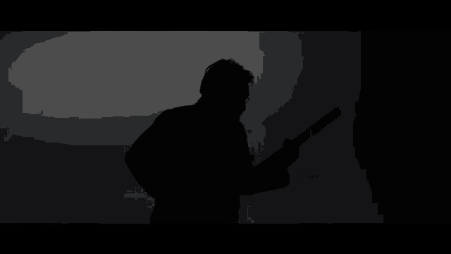 a silhouette of a man playing a guitar on a white background