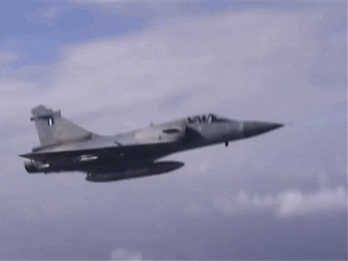 a fighter jet with the letter d on the tail is flying through the sky