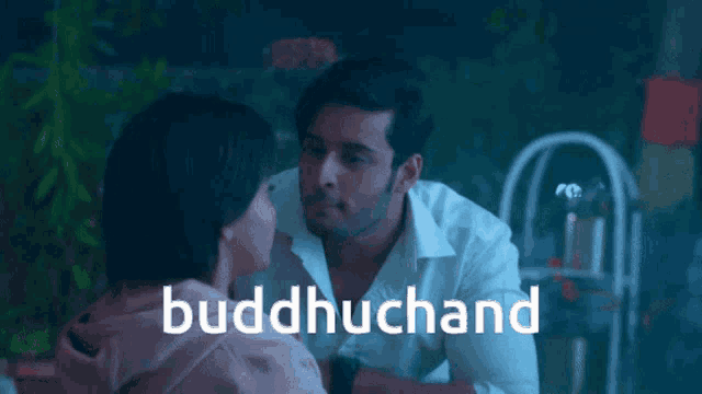 a man and a woman are kissing and the word buddhuchand is visible