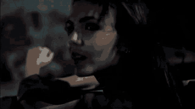 a close up of a woman 's face with a blurred background
