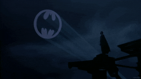 a silhouette of a man with an umbrella in front of a batman logo in the sky