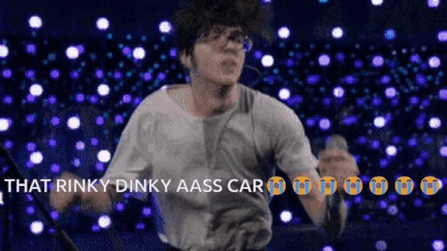 a man singing into a microphone with the words that rinky dinky aass car on the bottom