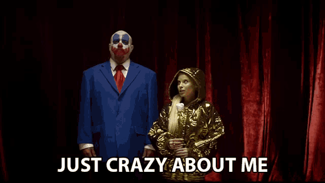a man in a blue suit and tie stands next to a woman in a gold jacket with the words just crazy about me written above them