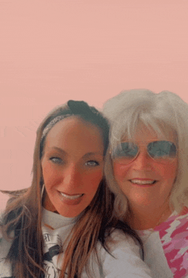 two women posing for a picture with one wearing sunglasses and the other wearing a headband