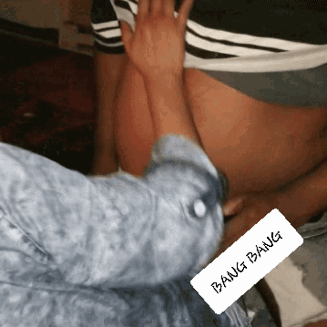a person is touching another person 's stomach and bang bang is written on the bottom