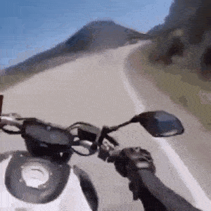 a person is riding a motorcycle on a curvy road .