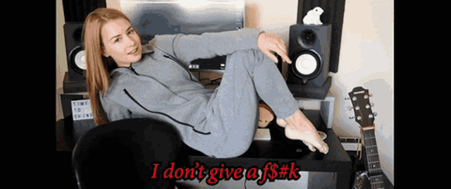 a woman sits at a desk with her legs crossed and the words i do n't give a f $ k written below her