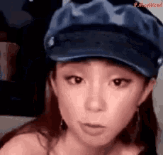 a woman wearing a blue hat has the word mad written on her face