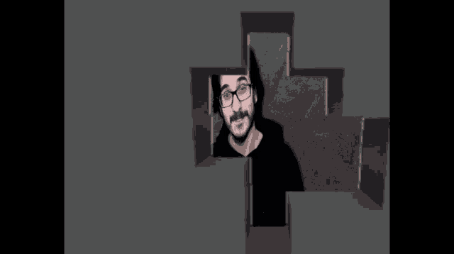 a man with glasses looks out of a hole in a cross