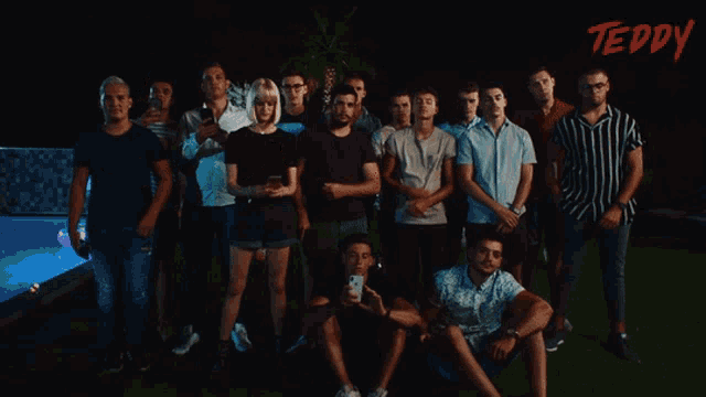 a group of people posing for a picture with the word teddy on the bottom right