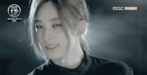 a close up of a woman 's face with mbc music written on the bottom
